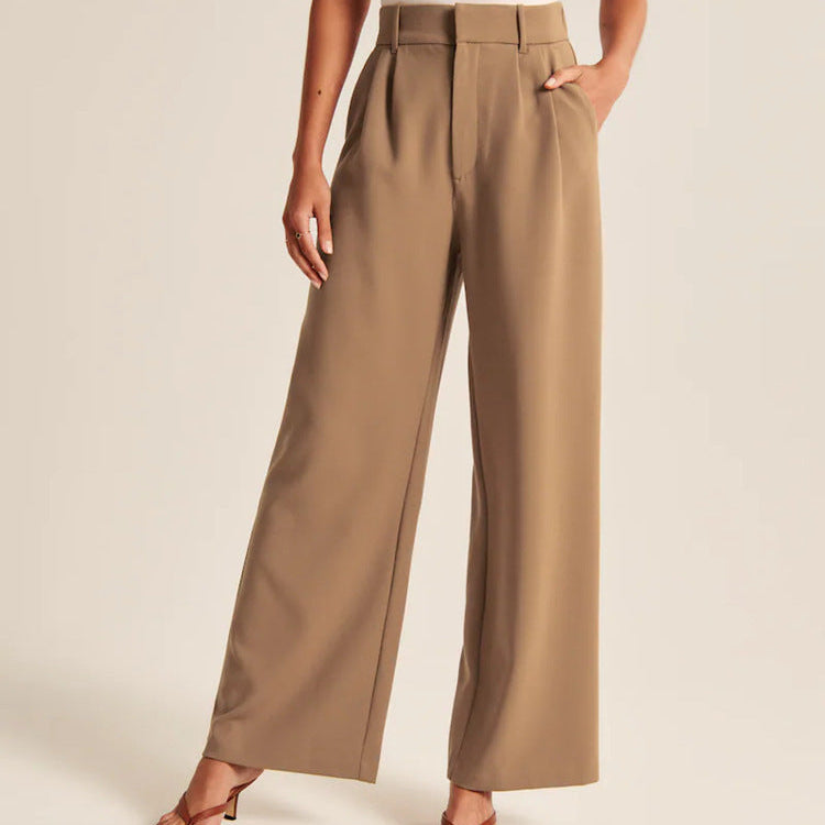 Person wearing beige wide-leg pants on a plain background